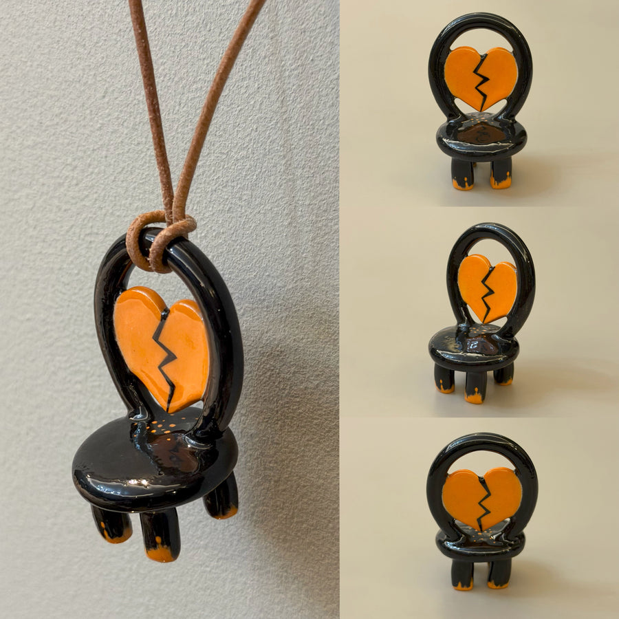 Sadness black ceramic chair necklace with orange broken heart – glossy view