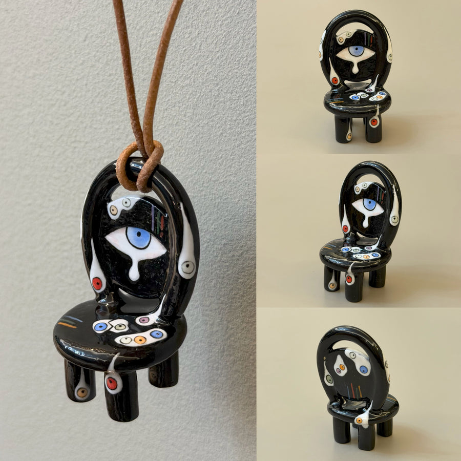 Nightmare black ceramic chair necklace with blue eye and white tear motif