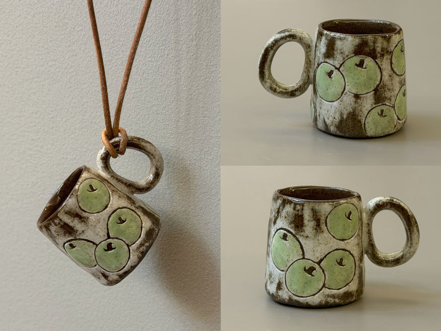 Apple ceramic cup necklace with pale green fruit pattern and brown glaze